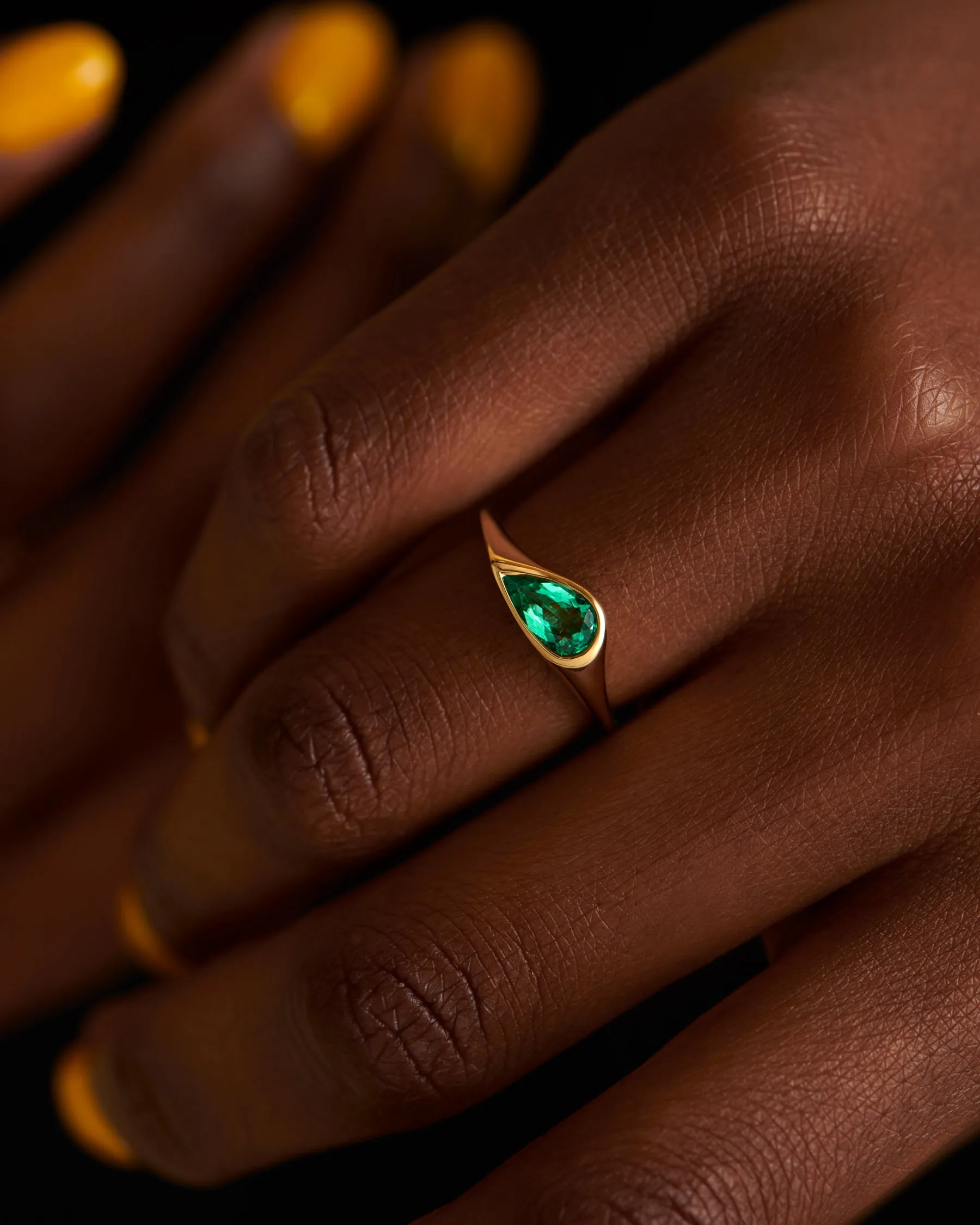 Solitaire Engagement Ring with a Pear Cut Emerald